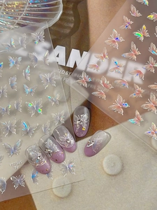 Detailed butterfly aurora nail stickers applied on gradient purple manicure with rhinestones