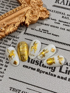 Detailed view of Baroque nail charms featuring golden Pegasus and 3D vintage patterns