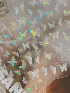 Macro shot of laser holographic butterfly nail stickers with colorful rainbow effect