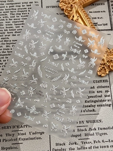 Detailed macro of 3D metallic silver Pegasus nail stickers with starry celestial designs