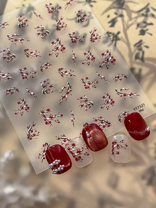 Detailed view of red winter plum nail stickers with gold relief and 3D floral accents