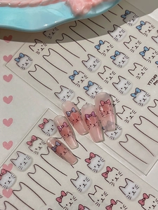 Close-up of cute white cat nail stickers with pink bows on soft gradient gradient nails