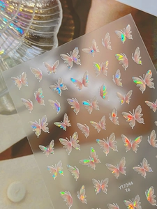 Detailed macro view of holographic butterfly nail art stickers with iridescent texture