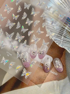 Detail of laser butterfly nail stickers with pearly aurora finish and crystal gems