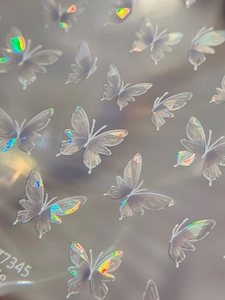 Macro shot of butterfly nail stickers T7345 featuring iridescent laser finish texture