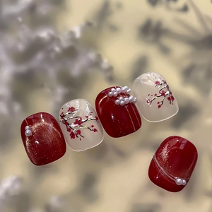 Handcrafted Chinese style press-on nails with red plum blossoms and pearl accents