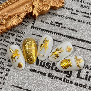 Golden pegasus nail art stickers with 3D embossed designs on white press-on nail set