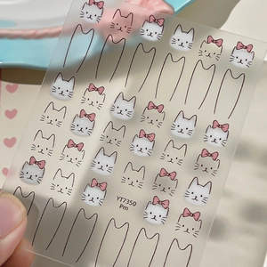 Cute cat face nail stickers featuring white kitten designs and black outline patterns
