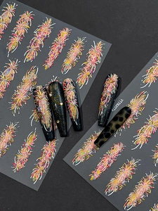 Macro detail of firework style nail stickers with glitter on long black pointed nails