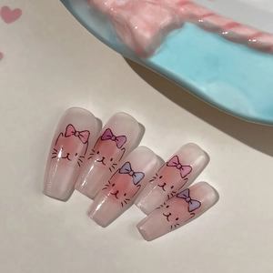 Cute pink gradient coffin nails featuring cartoon cat faces and colorful bows