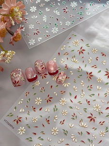 Detail of floral nail stickers with gold embossed edges and 3D leaf designs