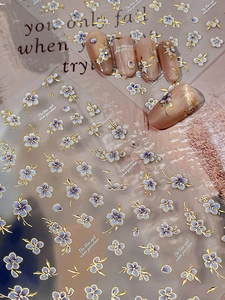 Blue porcelain style nail stickers with gold outlines on elegant display card