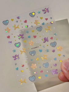 Dettaglio di adesivi per unghie cane palloncino macaron e fiore con laser