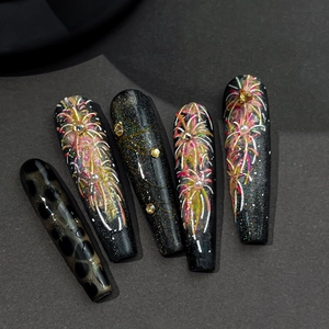 Luxurious black firework nail tips with pearls and leopard patterns for New Year
