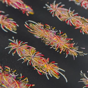 Sparkly red and white feather nail art stickers with UV glitter for New Year manicure