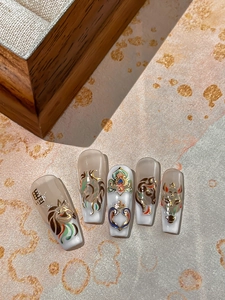 Detail of Year of the Horse nail art stickers with traditional lion dance and cloud motifs