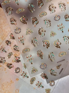 Macro detail of 5D embossed horse-themed nail stickers with vintage patterns and gold accents