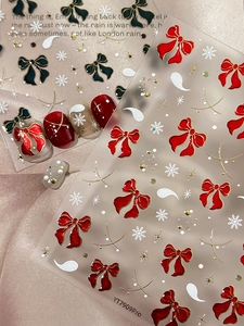 Macro view of 3D bow and snowflake nail stickers YT7909Pro with festive gold details