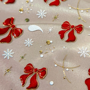 3D festive nail stickers with red bows, white snowflakes and golden glitter details
