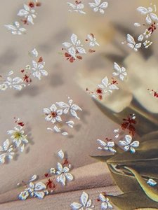 Macro shot of embossed white floral nail stickers with intricate 3D petal texture details