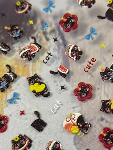 Vue macro des autocollants d'ongles 3D en relief avec chats noirs et nœuds bleus