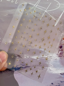 Detailed view of gold star nail stickers with sparkling crystal rhinestones and stars