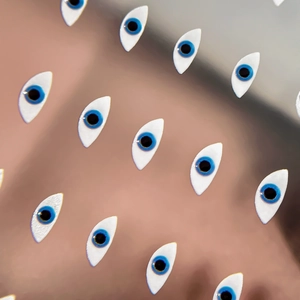 Minimalist evil eye nail art stickers featuring blue and white nazar eye motifs