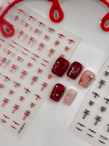 Detail of red Chinese knot nail stickers with pearls for traditional festive nail art
