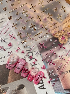 Detail of 3D embossed leopard heart and cross nail stickers on pink gradient nails