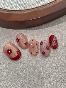 Detailed view of red and pink embossed 3D flower nail stickers with lace and polka dots