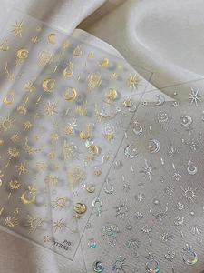 Detail of celestial gold and silver nail stickers with sun, moon, and star patterns