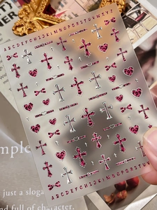 Detail of pink leopard print nail stickers with silver crosses and Y2K heart motifs