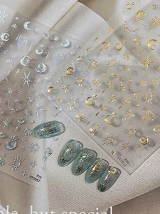 Detailed 3D star and moon nail stickers with metallic gold and silver celestial designs
