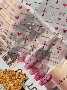 Close-up of pink leopard heart and cross nail stickers with 26 alphabets design