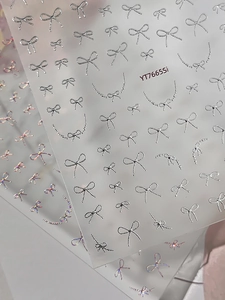 Silver 3D bow nail stickers with metallic finish and chain designs for nail art decoration