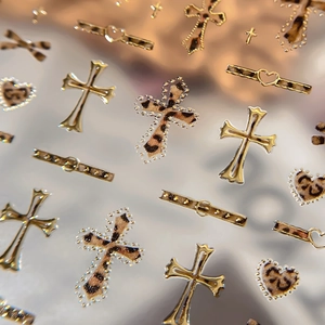 3D embossed leopard print nail stickers featuring golden hearts and metallic cross patterns