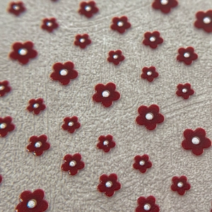3D relief red floral nail art stickers with silver centers on textured background
