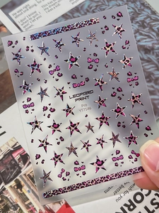 Detail of YT7546 nail stickers featuring purple leopard print, stars and laser finish