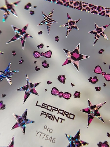 Macro shot of 3D laser leopard print nail art stickers with pink and purple glitter stars
