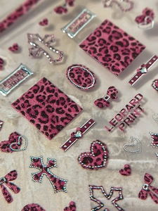 Detail of 3D leopard print nail stickers with pink hearts and silver embossed edges