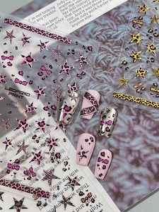 Detail view of leopard print and star nail art stickers with 3D metallic texture stickers