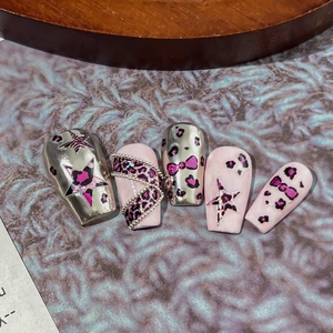 Long trapezoid press-on nails with silver metallic finish and leopard star designs