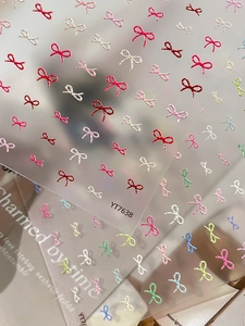 Macro view of 3D embossed colorful bow nail art stickers with relief texture