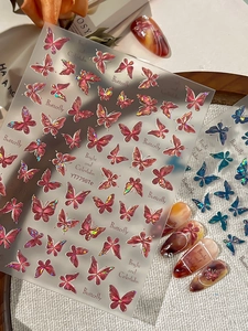 Macro shot of 3D laser pink butterfly nail stickers with holographic metallic finish