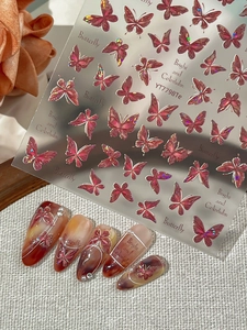 Detail of 5D embossed butterfly nail stickers with laser metallic edges and pink accents