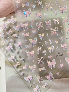 Detailed holographic laser nail art stickers featuring 3D bowknot and heart patterns