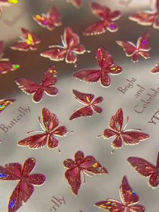 Macro shot of 3D laser butterfly nail stickers with colorful holographic finish