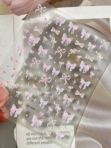 Close-up of YT7686 iridescent cartoon bow nail stickers with laser purple embossed details