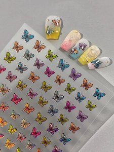 Detail view of multi-color laser butterfly nail stickers with shiny metallic finish