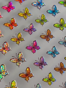Macro detail of laser holographic butterfly nail art stickers with iridescent texture